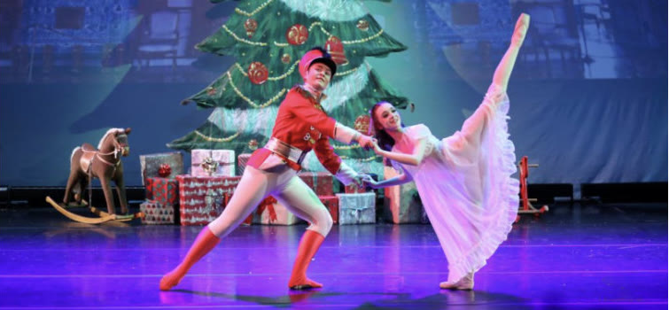 Youth Ballet West dancers as the Nutcracker soldier and Clara on stage in front of a Christmas tree
